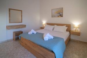 a bedroom with two beds with towels on them at Arezina's Apartment in Vromolithos