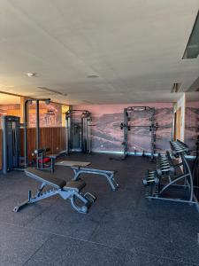 a gym with several exercise machines and a mural at Paraiso Douro in Lamego