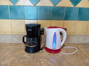 a toaster and a coffee maker on a counter at HOTEL AZOuR in Agadir