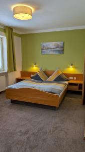 a bedroom with a large wooden bed in a room at Gasthof Postgarten in Furth im Wald
