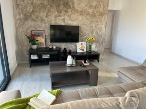 a living room with a couch and a coffee table at Villa relax glinado luluvo in Glinado Naxos