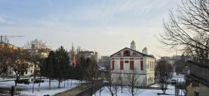 a building in a city with snow on the ground at Vila Alexandra - Prime accomodation - Pumo Properties in Bucharest