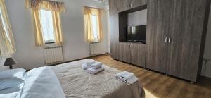 a bedroom with a bed with a teddy bear on it at Vila Alexandra - Prime accomodation - Pumo Properties in Bucharest