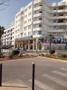 an empty street in front of a large building at HOTEL AZOuR in Agadir
