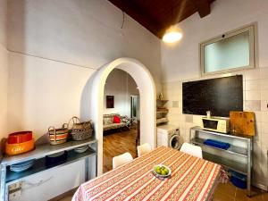 a dining room with a table and a tv at Vintage Flat, Centro storico, Cagliari in Cagliari