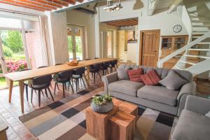 a living room with a couch and a table at Petrus Wittebrood Hoeve in Dikkelvenne