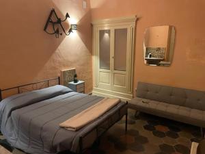 a bedroom with a bed and a couch at Casa Mari in Manduria