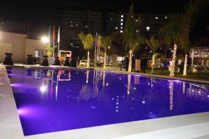 a swimming pool at night with christmas lights at Vila Lira in Durrës
