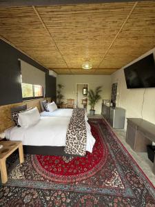 a bedroom with a large bed and a rug at Glorious Stay in Porterville