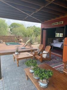 a patio with tables and chairs and a bed at Glorious Stay in Porterville