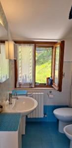a bathroom with a sink and a toilet and a window at Rifugio collina del Sacro Cuore in Ascoli Piceno +6 photos
