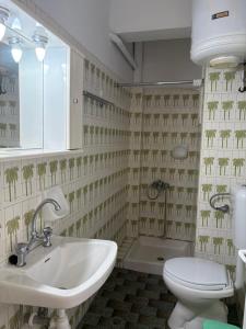 a bathroom with a sink and a toilet at Elena Rooms in Agios Nikitas +82 photos