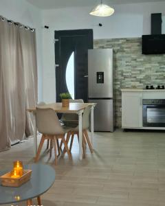 a kitchen with a table and chairs and a refrigerator at Amana in Bandraboua +1 photo