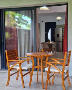 a wooden table and two chairs and a table and chairs at Amana in Bandraboua