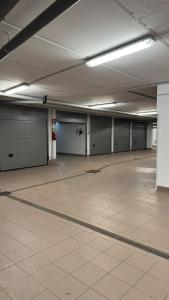 an empty parking garage with doors and a tiled floor at Duplex Esclusivo Bardonecchia - Centro - Garage in Bardonecchia