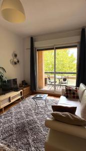 a living room with a couch and a large window at La Rotonde in Aix-en-Provence