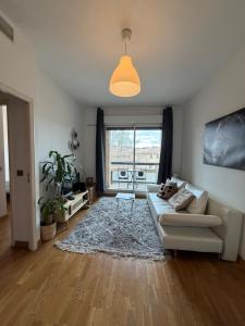 a living room with a couch and a large window at La Rotonde in Aix-en-Provence