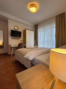 a hotel room with a large bed and a desk at Apartments Ivančić in Novi Vinodolski