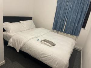 a bed with a towel on top of it at Ermihouse in Sheffield +4 photos