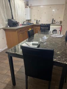 a kitchen with a counter and a table with a bowl on it at Ermihouse in Sheffield