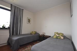 a bedroom with two beds and a window at apartmaji LEJARDIN in Škofljica