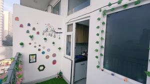 a room with a large window and a wall with plants at NXone STUDIO APARTMENT in Noida +1 photo