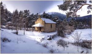 a small church in a snow covered field at Hotel Lucía in San Rafael