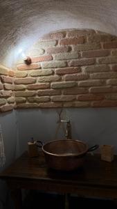 a bathroom with a sink on a brick wall at Rabat Home Luxury in Tursi +35 photos