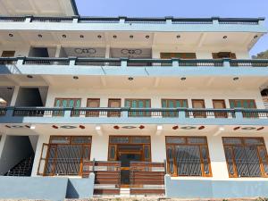 an external view of a building with a balcony at Skyline Hotel in Uttarkāshi