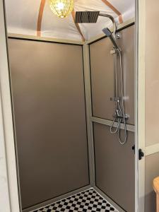 a bathroom with a shower with a sliding door at Merzouga Dream Camp in Merzouga +34 photos