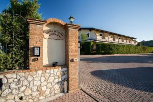 a brick wall with a sign on the side of a building at Villa Santa Caterina in Montalto Uffugo