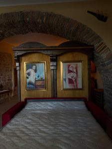 a bed in a room with two pictures on the wall at Rabat Home Luxury in Tursi