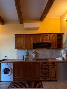 a kitchen with a sink and a washing machine at Rabat Home Luxury in Tursi