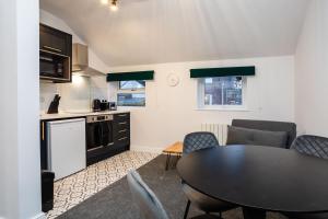 a kitchen and dining room with a table and chairs at Loft-Style Studio with Skylights and Parking in Doncaster
