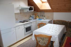 a kitchen with a table and a white counter top at Schröckerhof in Mariapfarr
