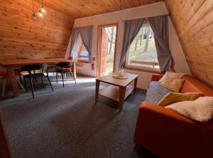 a living room with a couch and a table at Domki Sosnówka-Kaszuby in Zgorzałe