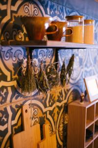 a shelf with a bowl and other items on a wall at Zöldre Néző Vendégház in Letkés +18 photos