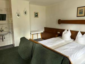 a hotel room with a bed and a sink at Appartement Unterstein 1 in Niedernsill