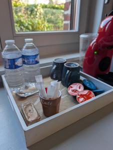 a tray with donuts and water bottles on a counter at Gîtes chez julie in Beaucamps-Ligny