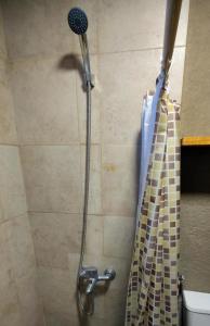 a shower with a shower head in a bathroom at Kima III in Huerta Grande