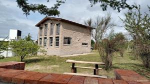 a bench sitting in front of a brick building at Kima III in Huerta Grande