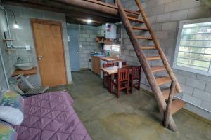 a kitchen with a staircase in a room at Kima III in Huerta Grande