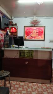 a reception desk with a laptop on top of it at Hotel Mahi in Jaipur