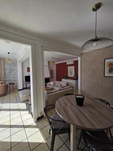 a living room with a table and a dining room at Maison Valras Plage très bon emplacement in Valras-Plage
