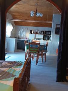 a kitchen and dining room with a table and chairs at Chez Sylvia in Saint-Julien-du-Pinet +18 photos