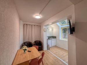 a dining room with a table and chairs at Studio Neuf Centre - Chambre Séparée - Parking in Bressuire