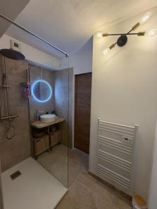 a bathroom with a glass shower with a sink at Le Roly's in Saint-Saturnin-lès-Avignon +23 photos