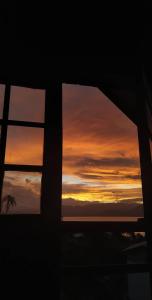 a view of a sunset through a window at Casa ceu in Florianópolis