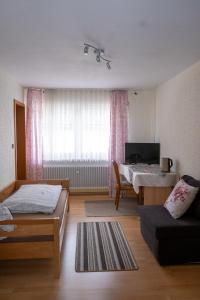 a living room with two beds and a couch at Zimmervermietung Peter in Zirndorf