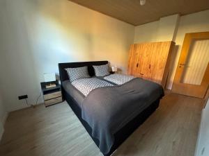 a bedroom with a large bed in a room at Canossa Lodge in Bad Harzburg
